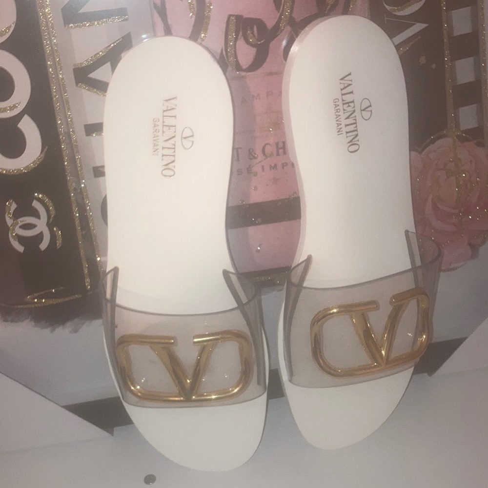 Valentino Garavani sandals with white sole and gold logo.